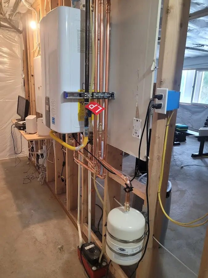 Licensed plumber repairing a kitchen sink in Elsmere